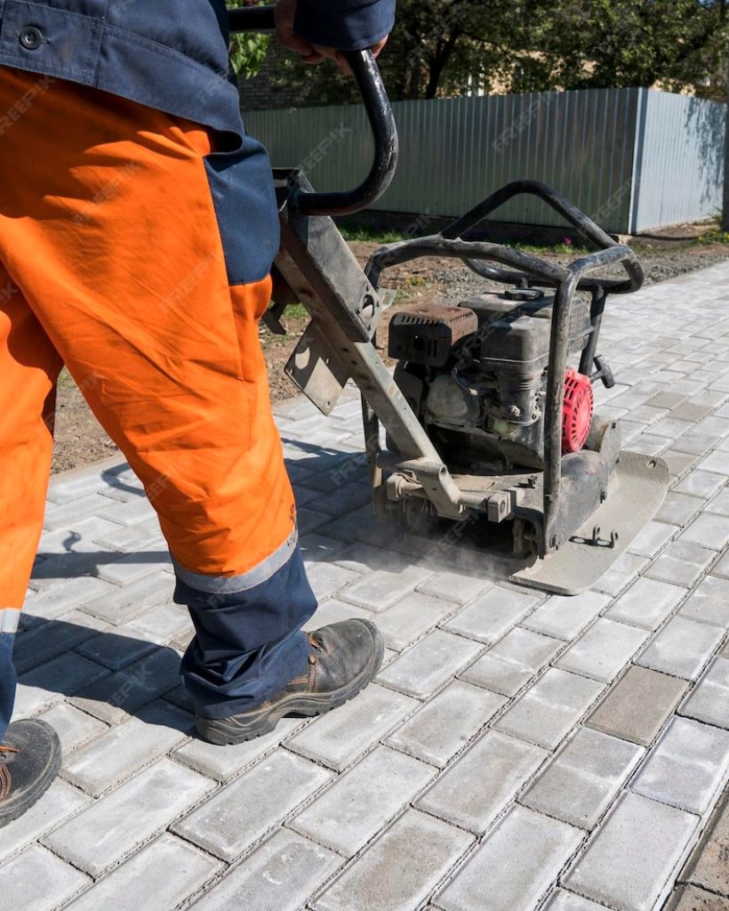 man-orange-uniform-using-vibrational-paving-stone-machine-finish-sidewalk_758740-1188 man-orange-uniform-using-vibrational-paving-stone-machine-finish-sidewalk_758740-1188