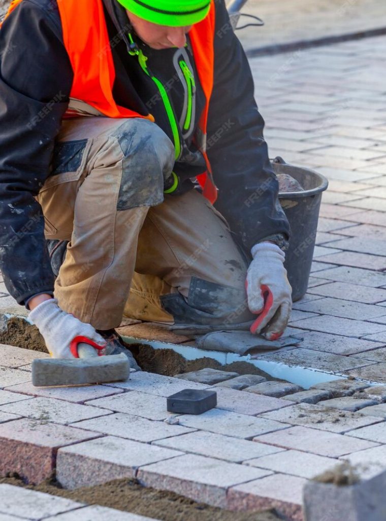 worker-lays-paving-stones-sidewalk_194646-4418 worker-lays-paving-stones-sidewalk_194646-4418
